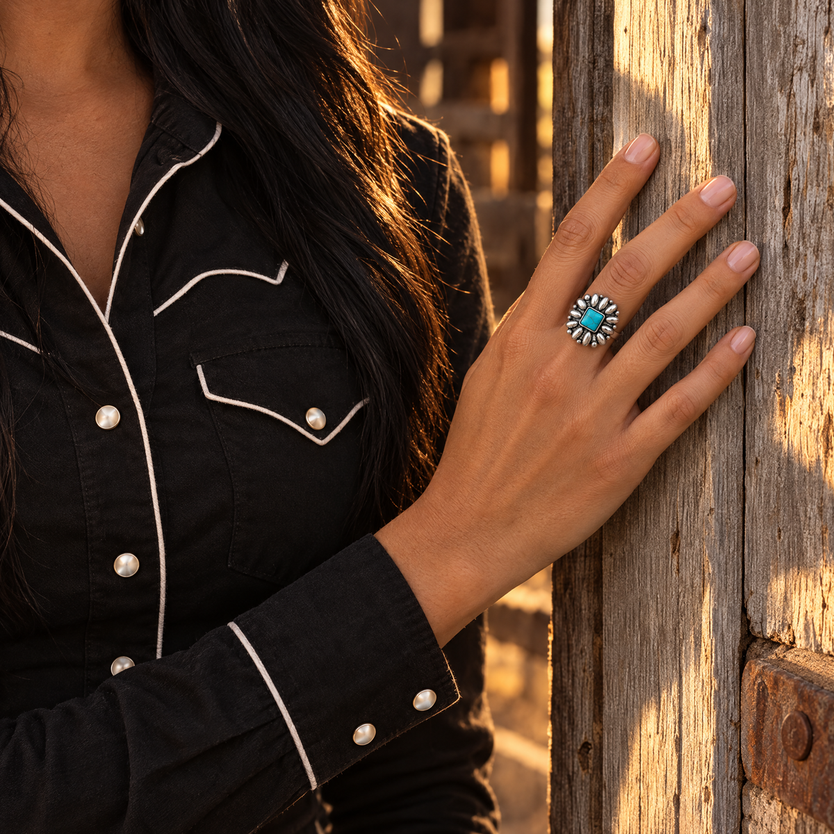 Silver Blossom Ring worn on hand resting on a weathered barn door frame