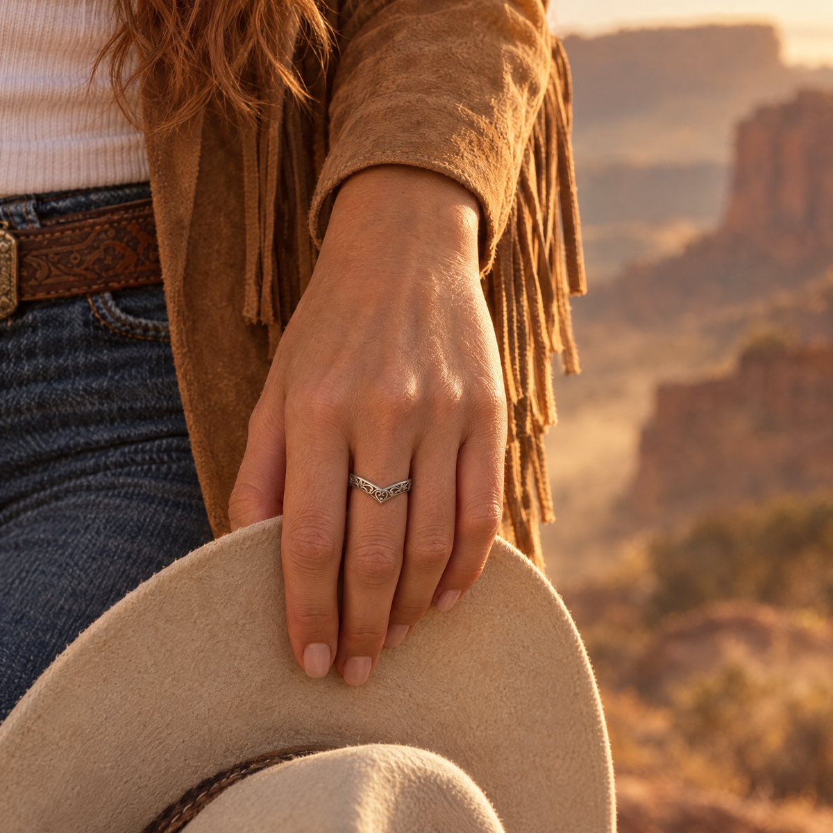 Cowgirl Wishbone Ring worn on hand holding a felt hat brim