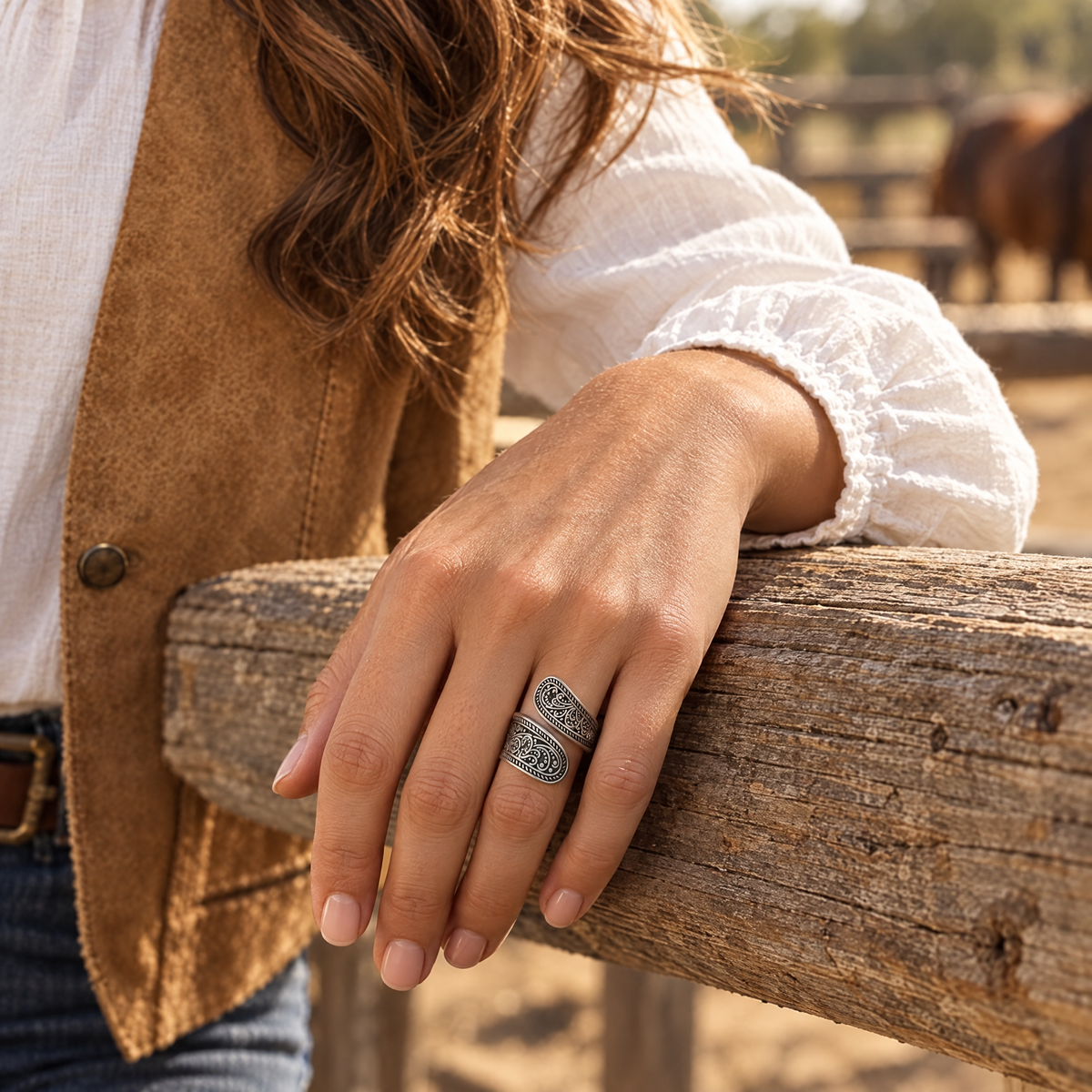 Hitchin' Post Ring worn on hand resting on a corral fence