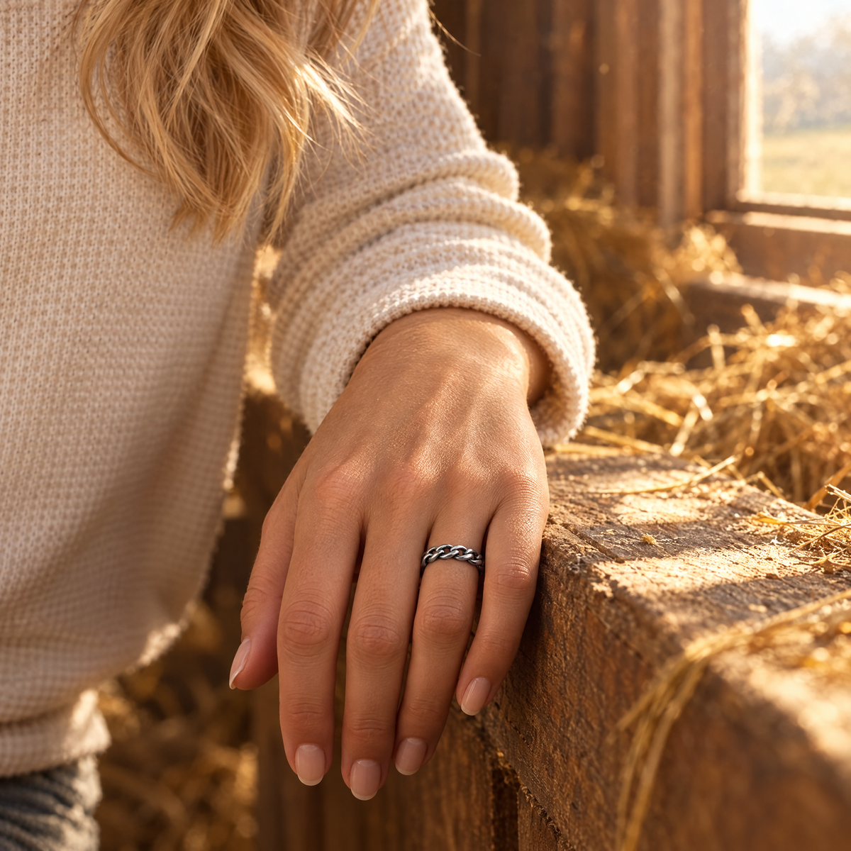 Braided Trail Ring worn on hand resting on a hay loft window ledge